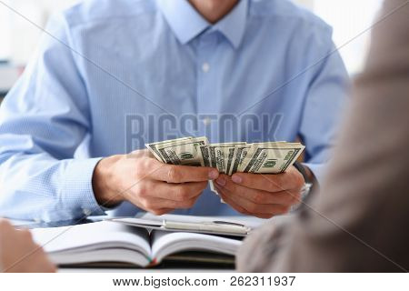 The Businessman Considers Cash Dollars In The Office Issues Salaries To Employees With Black Cash Di