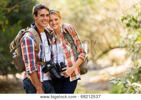 happy young couple hiking in mountain