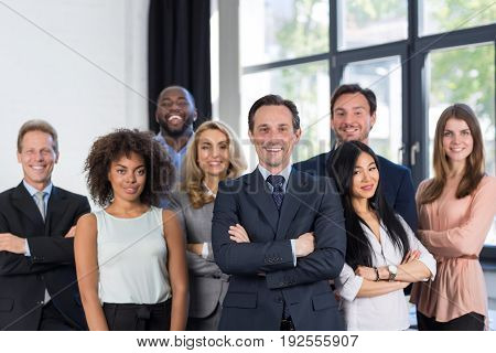 Boss And Business People Group With Mature Leader On Foreground In Office, Leadership Concept, Successful Mix Race Team Of Businesspeople Wearing Suits, Professional Staff Happy Smiling