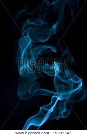 Teal smoke wisp rising against  black background