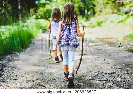 Children - Twin Girls Are Hiking In The Mountains.