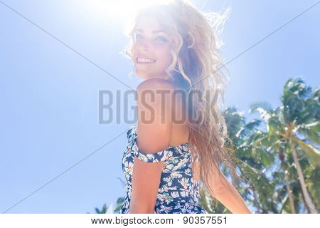 young happy girl with flower bouquet on tropical sea and beach background, smiling happy girl outdoor portrait