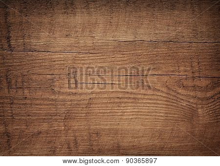 Dark brown scratched wooden cutting board. Wood texture