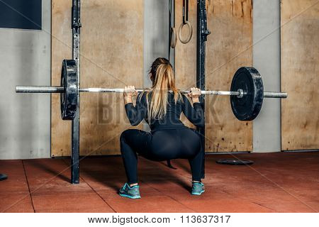 Back view attractive girl working out legs