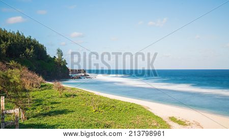 beautiful sandy beach and blue indian oceanGris Gris tropical beach cape on South of Mauritiusused nd filter for long exposure.