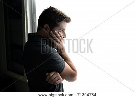 Attractive Man Looking Through Window Suffering Emotional Crisis And Depression