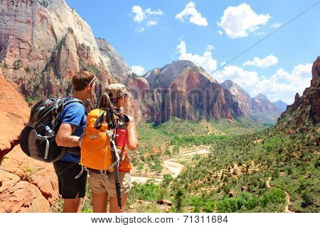 Hiking - hikers looking at view in Zion National park. People living healthy active lifestyle dong hike in beautiful nature landscape to Observation Point near Angles Landing, Zion Canyon, Utah, USA.