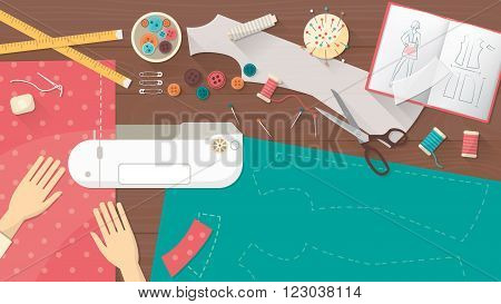 Professional seamstress sewing a dress using a sewing machine tailor work table top view with sewing equipment