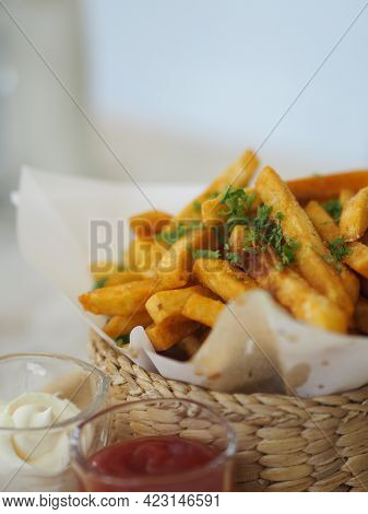 French Fries, Potato Chips Yellow Crispy Fries In Wooden Basket With Tomato Sauce And Mayonnaise In 