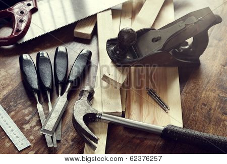 Old antique woodworking or carpentry tools on a hardwood floor concept for construction or repairing