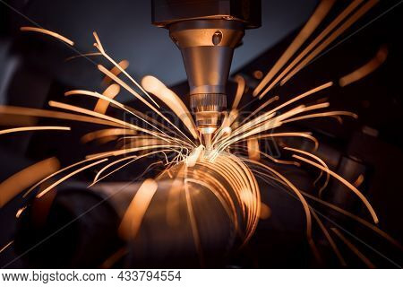 CNC Laser cutting of metal, modern industrial technology Making Industrial Details. The laser optics and CNC (computer numerical control) are used to direct the material or the laser beam generated.