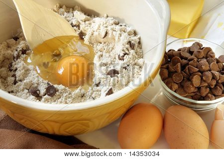 Baking chocolate chip cookies.  Mixing bowl with flour, eggs, chocolate chips and butter.