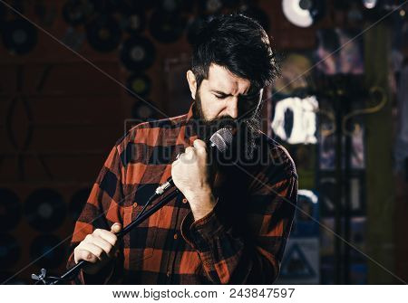 Music And Leisure Concept. Man With Enthusiastic Face Holds Microphone, Singing Song, Karaoke Club B