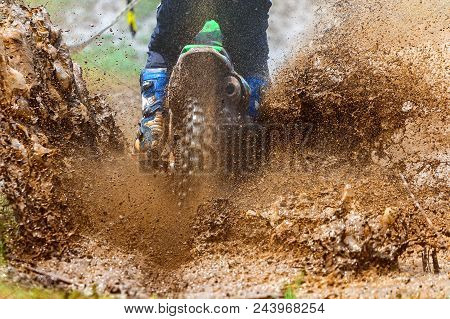 Enduro Rides Through The Mud With Big Splash,driver Splashing Mud On Wet And Muddy Terrain,motocross