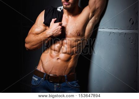 Muscular and sexy torso of young man with perfect abs. Athletic body of young hunk. Fitness concept.