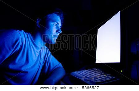 Man in front of computer. Dark night room.