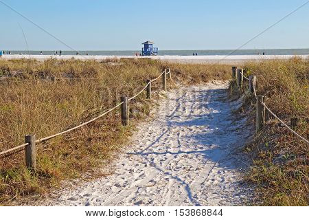 Walkway to the white sand beach and lifeguard station at Siesta Key Beach near Sarasota Florida