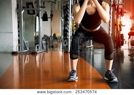 Fitness Woman Doing Squat Workout For Fat Burning And Legs Strength In Fitness Sports Gym With Sport