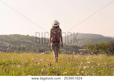 Girl in vacation. Summer vacation. Traveler girl walking through fields. Young girl traveler walking in nature. Traveler with backpack in nature. Girl traveler walk through nature in summer day. Traveler. Summer. Backpack. Girl. Walk. Nature. Vacation. Li