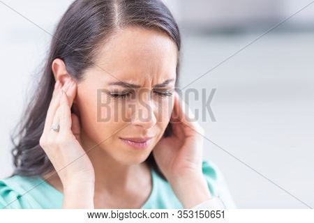 Young Woman Have Headache Migraine Stress Or Tinnitus - Noise Whistling In Her Ears