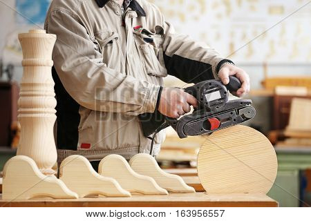 Man doing woodwork in a carpentry. Woodworker