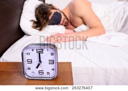 Healthy Sleep Tips. Alarm Clock Before Ringing. Man In Eye Mask Sleep Better. Guy Prefer Relax In Da