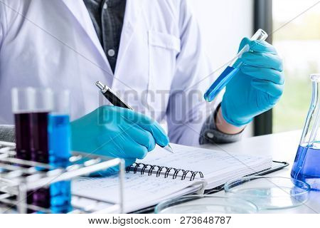 Biochemistry Laboratory Research, Chemist Is Analyzing Sample And Record In Laboratory With Equipmen