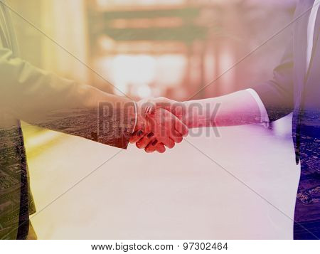 Double exposure design. Business partners concept with businessman and businesswoman handshake at modern office indoors