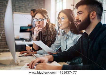 Company employees working in software development and designer office