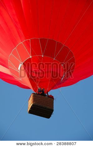 Red balloon flying in the air.