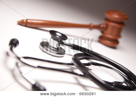 Gavel And Stethoscope On Gradated Background