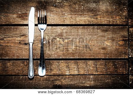 Silver Knife and fork over wooden table