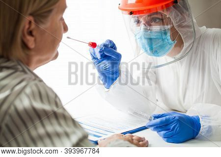 Physician Wearing Personal Protective Equipment Performing A Coronavirus Covid-19 Pcr Test, Patient 