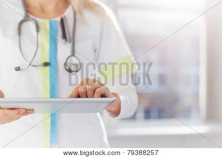 Woman doctor using tablet computer