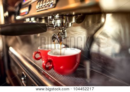 Coffee Machine Preparing Fresh Coffee And Pouring Into Red Cups At Restaurant, Bar Or Pub.