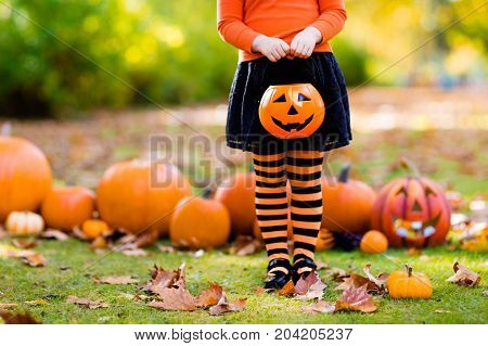 Little Girl In Witch Costume On Halloween Trick Or Treat