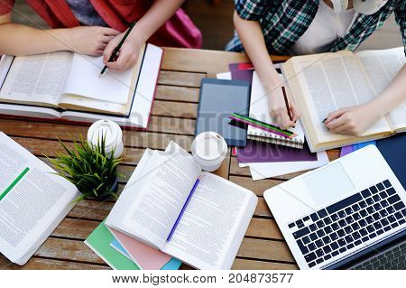 Top View Of Young Students With Books And Notes In Cafe