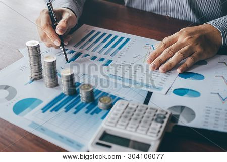 Businessman Accountant Counting Money And Making Notes At Report Doing Finances And Calculate About