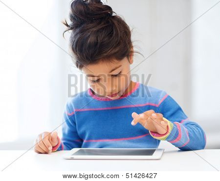 education, school, technology and internet concept - little student girl with tablet pc at home