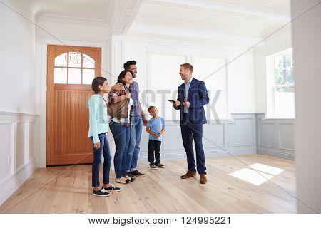 Realtor Showing Hispanic Family Around New Home