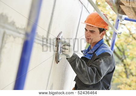 builder worker facade building with sandpaper