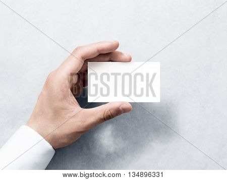 Hand hold blank plain white business card design mockup. Clear calling card mock up template holding arm. Visit pasteboard paper surface display front. Check small offset card print. Business branding