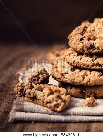 Chocolate Chip Cookies On Natural Linen Napkin On Wooden Background.  Pile Of Chocolate Chip Cookies