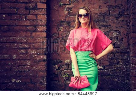 Beautiful Fashionable Woman at the Brick Wall