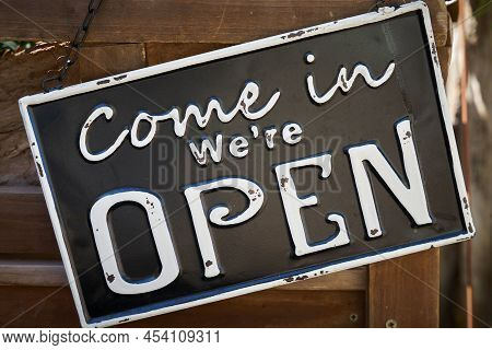 Sign On The Front Door Of A Store With The Words Come In We Are Open