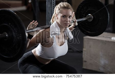 Girl Making Squat With Barbell