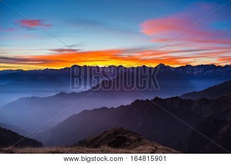 Mountain Silhouette And Stunning Sky With Moon At Sunset