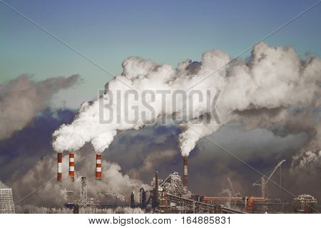 Poor environment in the city. Environmental disaster. Harmful emissions into the environment. Smoke and smog. Pollution of the atmosphere by plants. Exhaust gases.