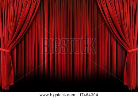 Red draped theater stage curtains with light and shadows