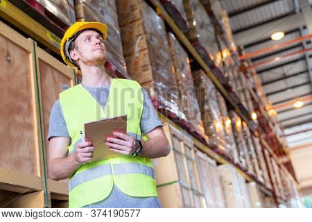 Portrait white caucasian warehouse worker stand with digital tablet for inventory checking in large warehouse distribution center. Reopening  Business warehouse technology and logistic concept